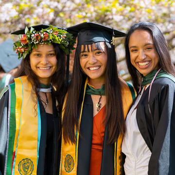 Three graduates pose for a photo
