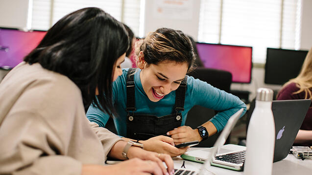 two students laughing together in class