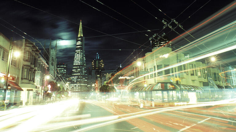 Light streaks illuminate a San Francisco street at night.