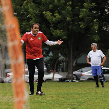A group of adults playing soccer