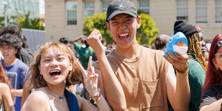 Students smiling and giving a peace sign