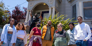 mcarthy center stydents stand together in front of victorian house