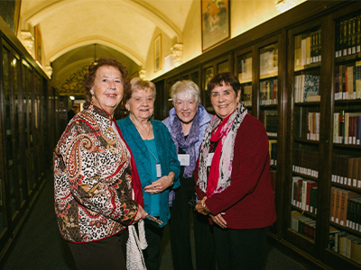 Four people together and smiling