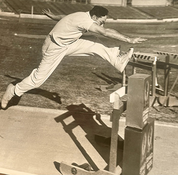 Person running track hurdles