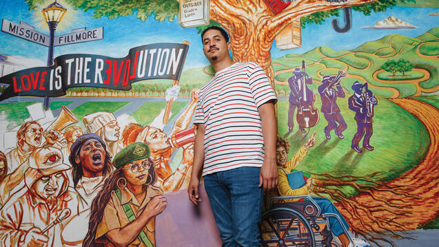 USF student in front of a mural