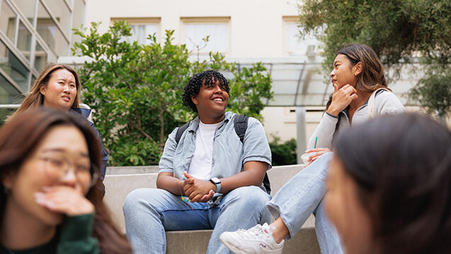 group of students smiling together outside