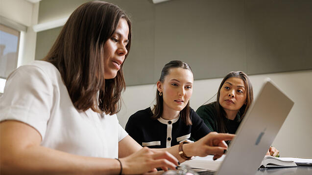 Three USF law students working on a project together