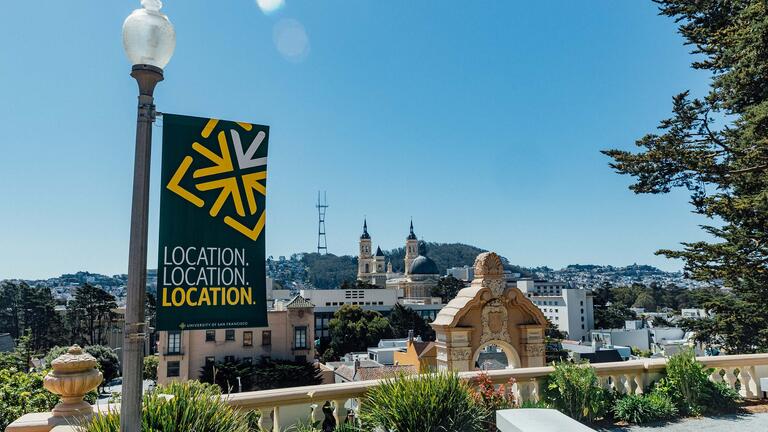 View from the top of Lone Mountain steps and a banner reading "Location. Location. Location."