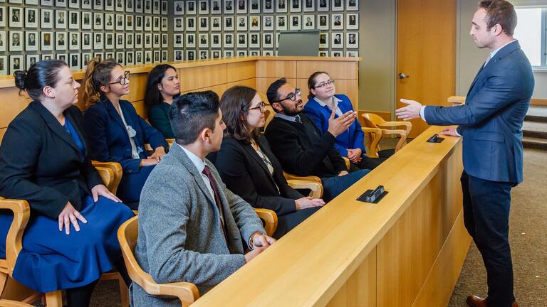 Student presents to a jury in moot court.