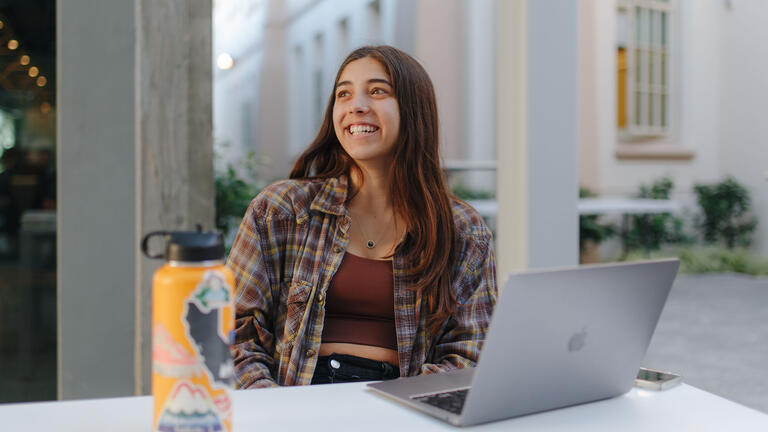 Student with a laptop studying.