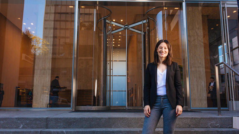 Alumni standing in front of building.