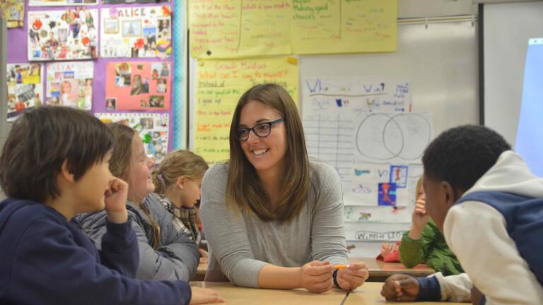 Student in a classroom of kids