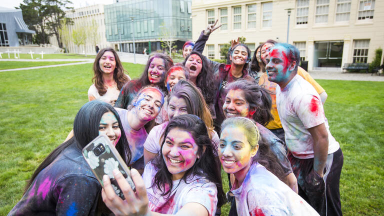 Students take a selfie during Holi Festival of Color at USF