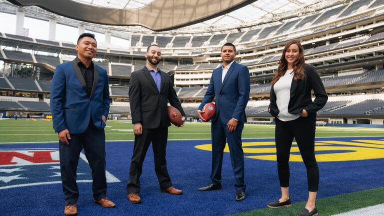 Four students on the field at SoFi Stadium