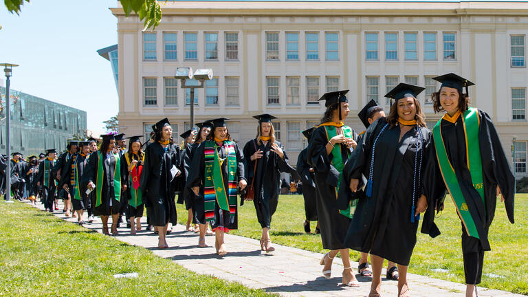 students line up for commencement outside