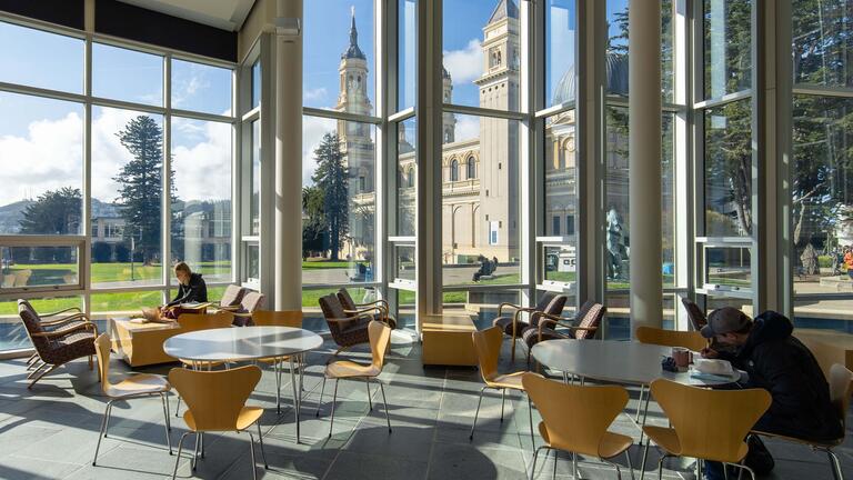 Students study in the atrium at Gleeson Library