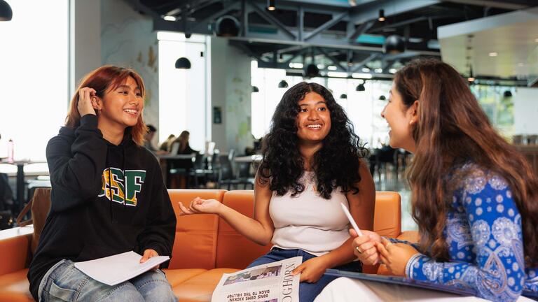 Three students talking to each other