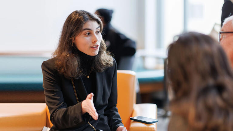 Person chatting with two others at an event