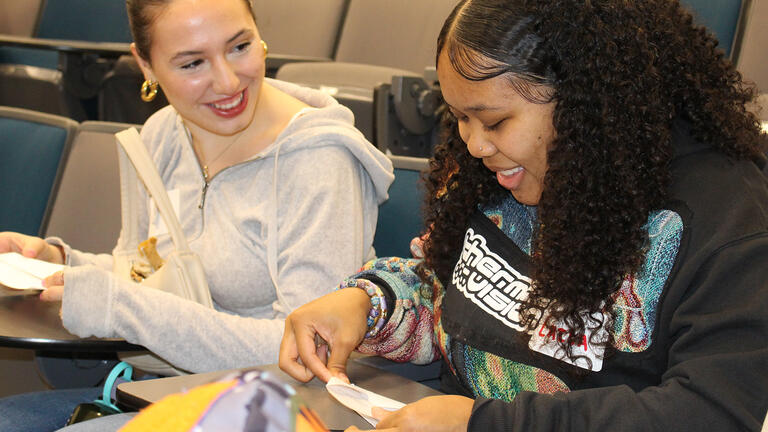usf student mentor folds airplanes with mentee