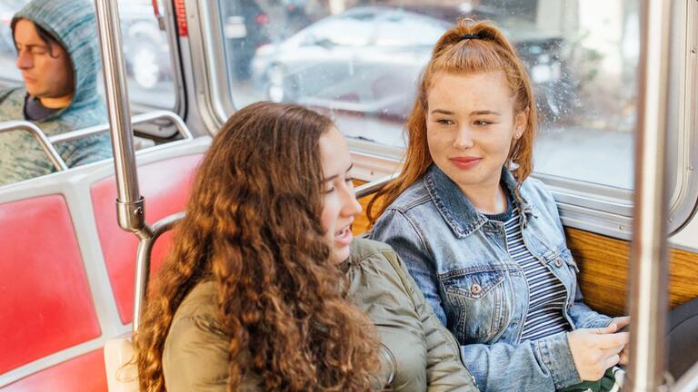 Two students sitting on a Muni bus