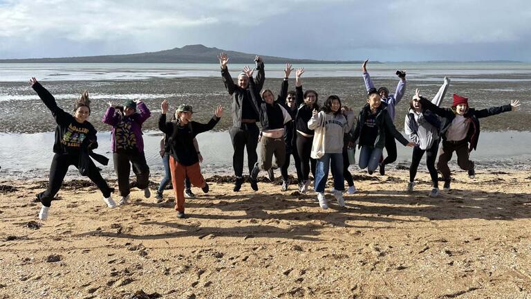 Group of students jumping up and posing in New Zealand