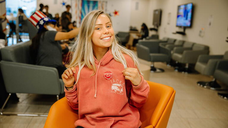 Student showing "I voted" sticker.