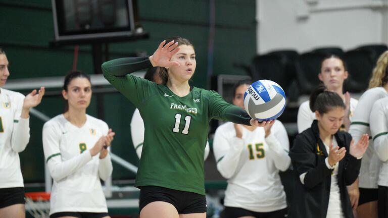 Volleyball player getting ready to serve a volleyball