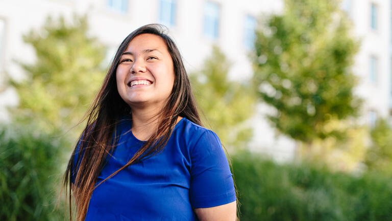 student smiling outside on usf campus