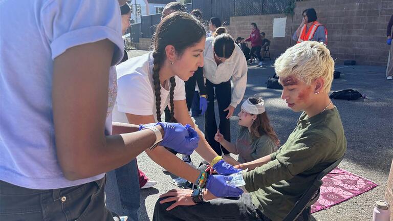 Nursing student treating an injured patient