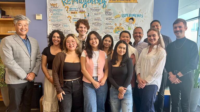 Students standing in front of a poster