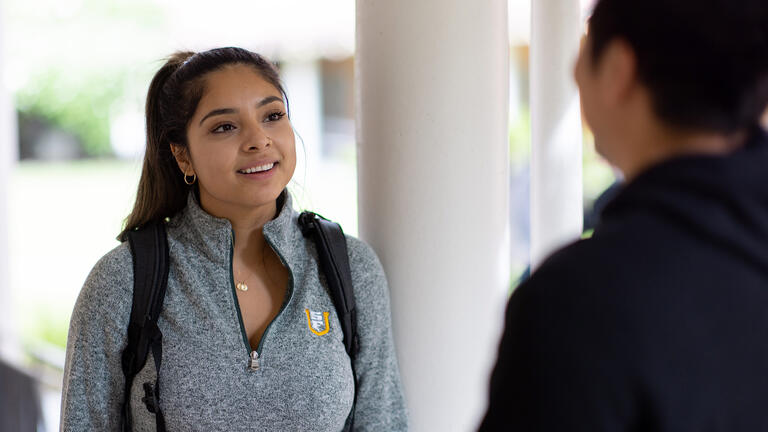 students talk outside at the OC campus