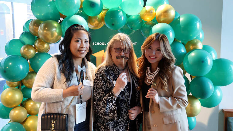 As part of Celebrate USF, guests gather for a 1920’s theme party on October 2024. The program included remarks by hospitality management student Angel Trang (right), MBA student Richard J. Cadiz, Dean Otgo Erhemjamts, and Fr. Paul Fitzgerald.