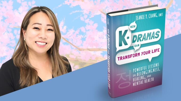 A person smiling with a Cherry Blossom Backdrop with a bookcover of How K-dramas can Transform your Life by Jeanie Chang in the foreground