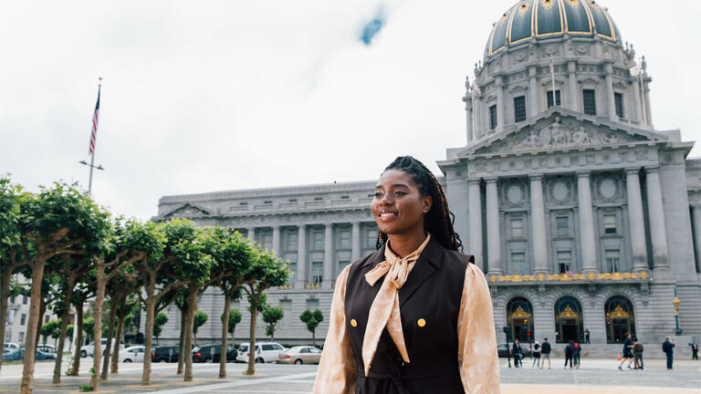 USF law student walking in front of San Francisco city hall