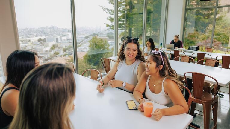 Students at table in Koret Lodge