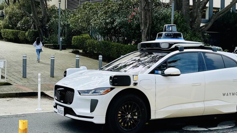 Waymo vehicle driving through campus