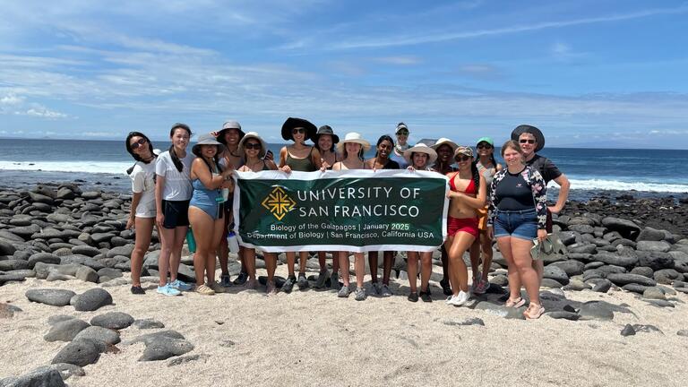 Students with a USF banner in Galapagos