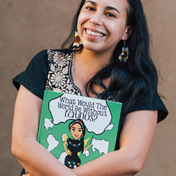 Araceli Leon holding her book and smiling