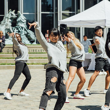 students perform a dance outside on usf campus