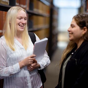 Students talking in a library