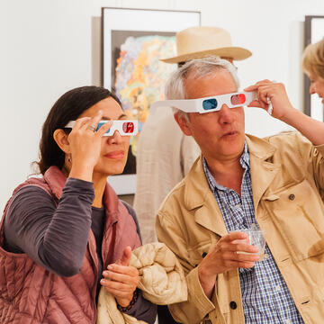two people put on goggles at art exhibiton