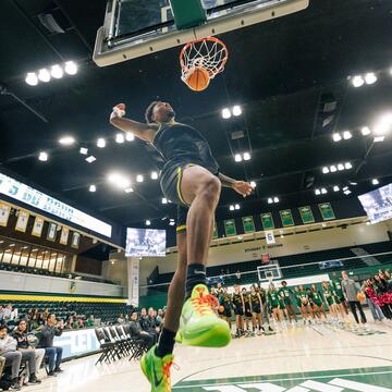 student athlete dunks basketball