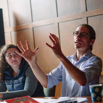 Professor teaching in a room to students