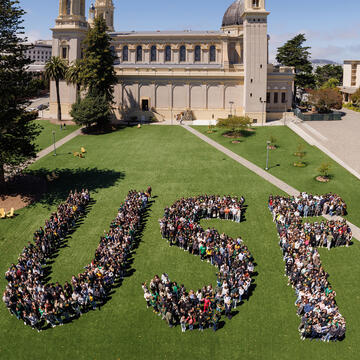 New class of students stand together to spell out USF