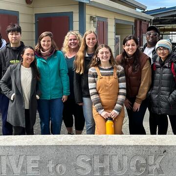 students stand at hog island oyster