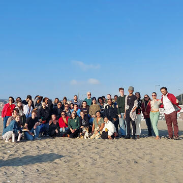 large group of graduate students at the beach