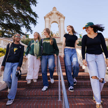 Group of students walks down a staircase.