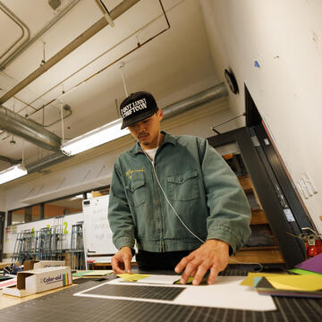 design student working with ruler guides and paper