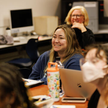 student laughs while sitting in class