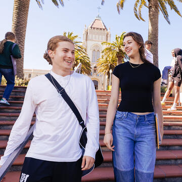 Two students walk down the Lone Mountain stairs